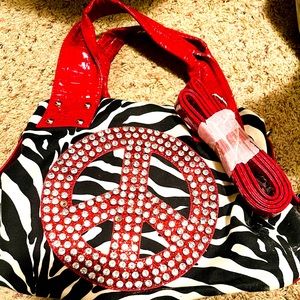 Very cute purse! Red, white, and black with one missing stone. Strap included.